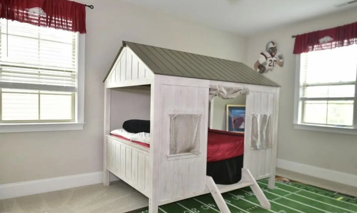 Children's bedroom designed with a custom bunk bed and football rug